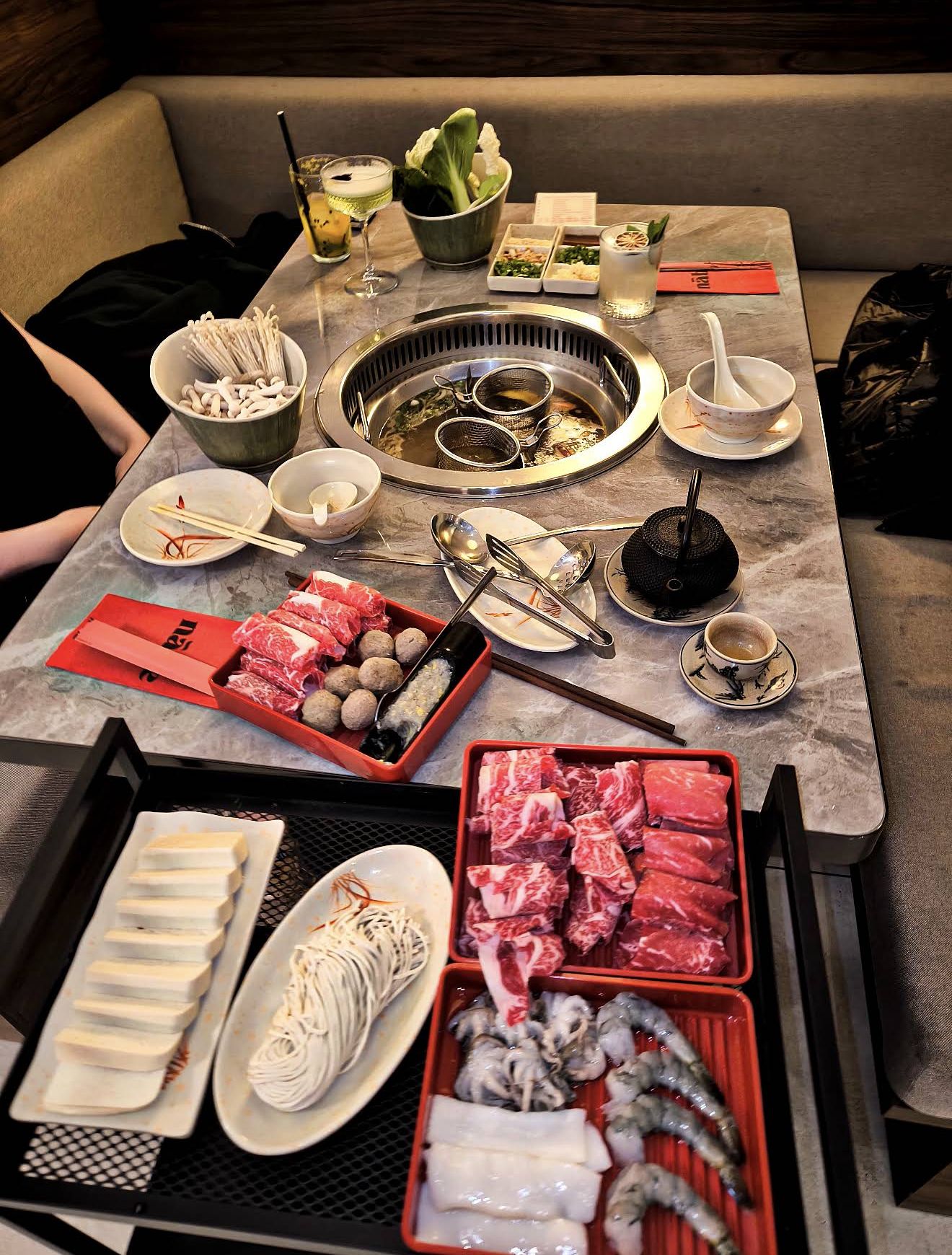 Table set for a group with hot pot and BBQ