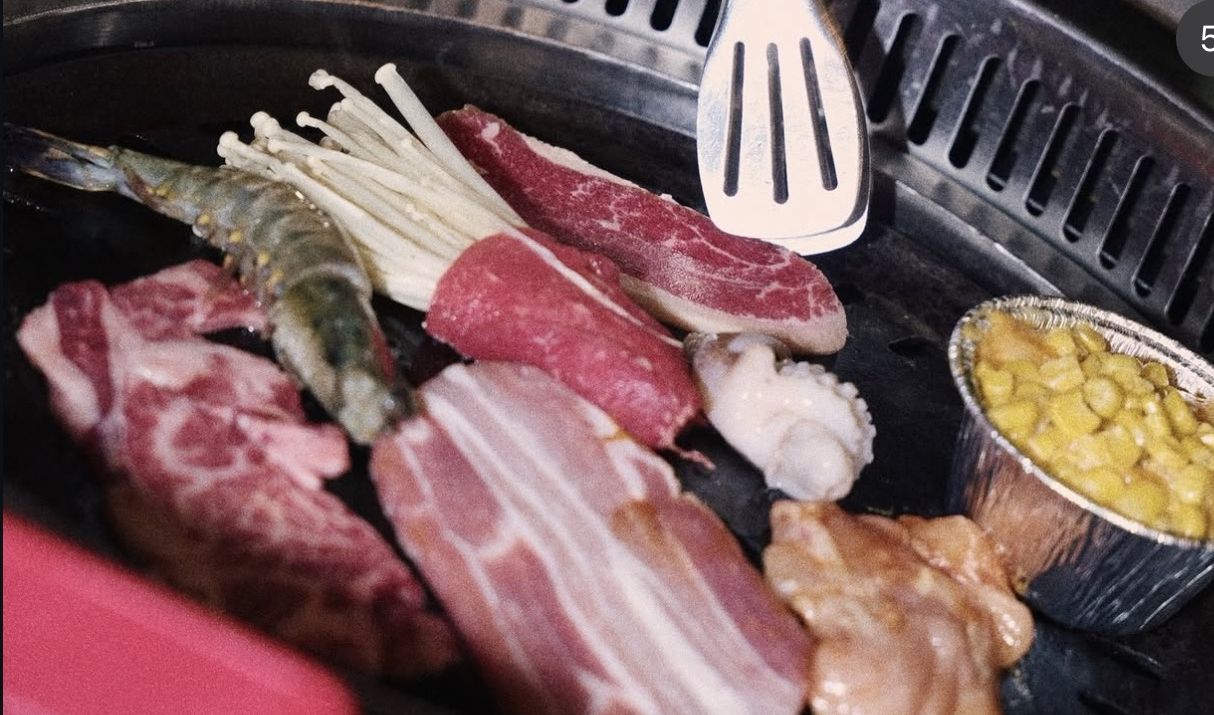 Korean BBQ grill with beef, pork belly, prawns and enoki
